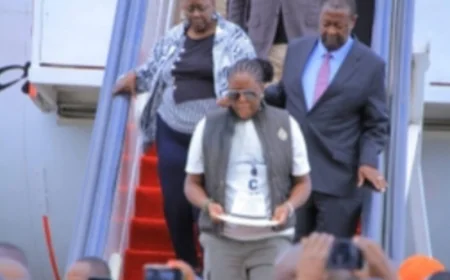 The Journey Home: Winnie Odinga carries Raila’s iconic white fedora hat at JKIA