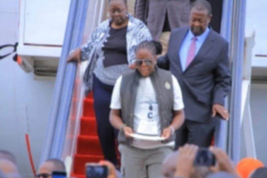 The Journey Home: Winnie Odinga carries Raila’s iconic white fedora hat at JKIA