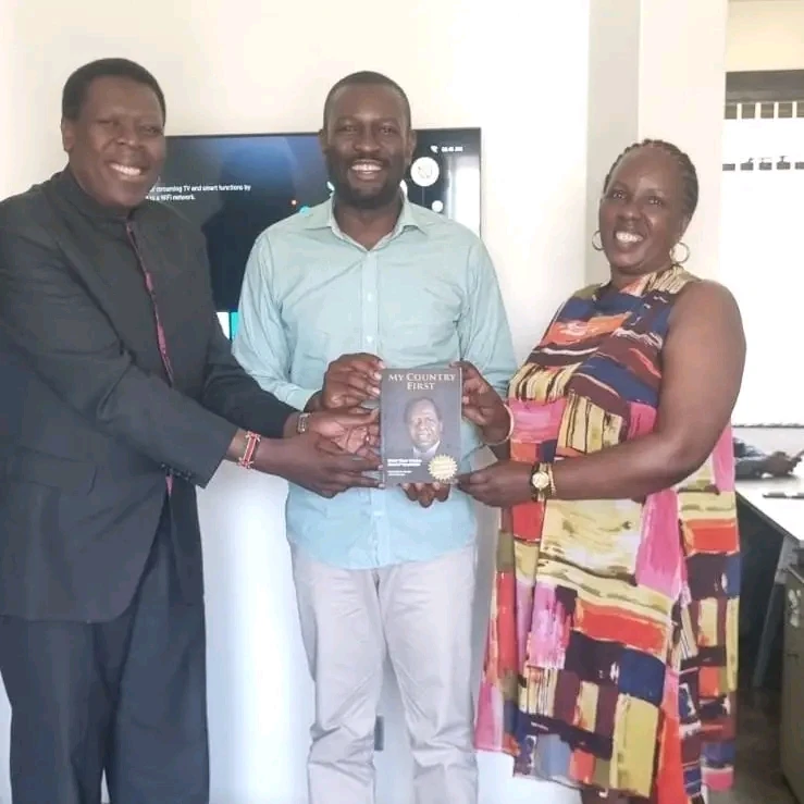 Eugene hands Sifuna Kijana Wamalwa's book