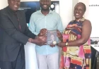 Eugene hands Sifuna Kijana Wamalwa's book