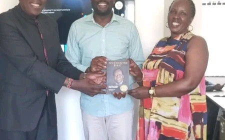Eugene hands Sifuna Kijana Wamalwa's book
