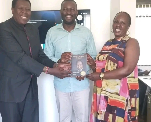 Eugene hands Sifuna Kijana Wamalwa's book
